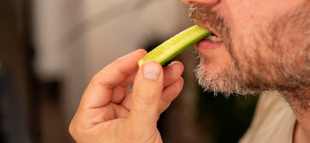 Photo a 43yearold man eats a cucumber close up natural shot