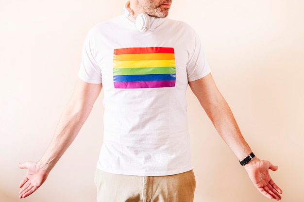 45 year old man wearing a white with pride flag t-shirt