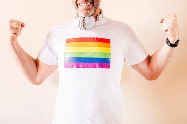 45 year old man wearing a white with pride flag t-shirt