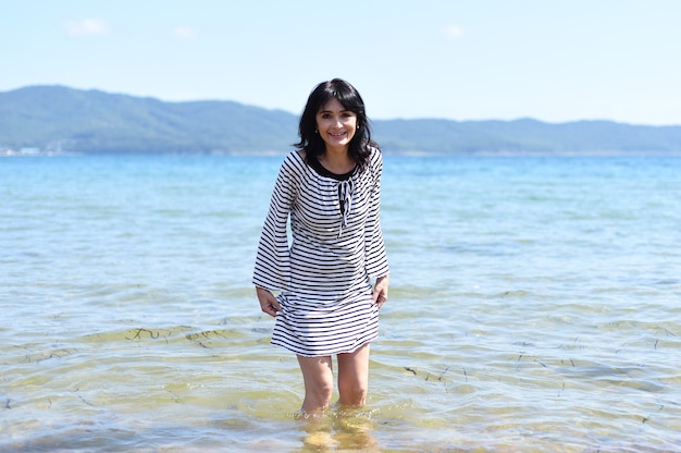 45 years old Russian woman laughing and standing in Japanese sea