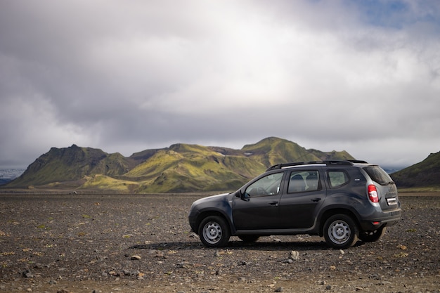 4x4 Car parked off road on the black lava field on the way to Landmannalaugar area, Iceland.