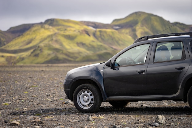 4x4 Car parked off road on the black lava field on the way to Landmannalaugar area, Iceland.