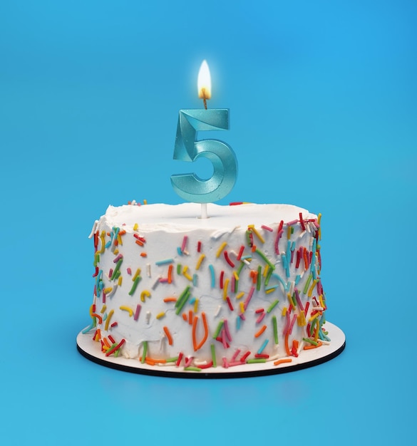 5 shaped candle light on happy birthday cake on blue