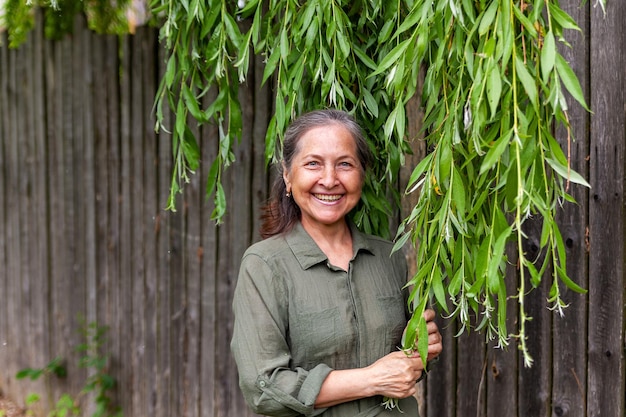 60yearold woman in green dress outdoors in summer