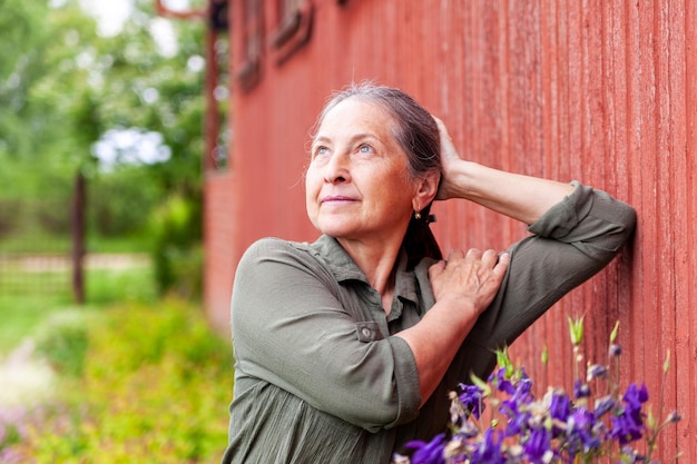 60yearold woman in green dress outdoors in summer