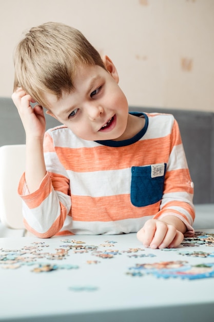 A 6yearold boy collects a puzzle at home and holds his head Development of fine motor skills and the brain