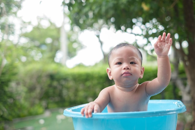 7 month old baby taking a bath in a good mood outdoors