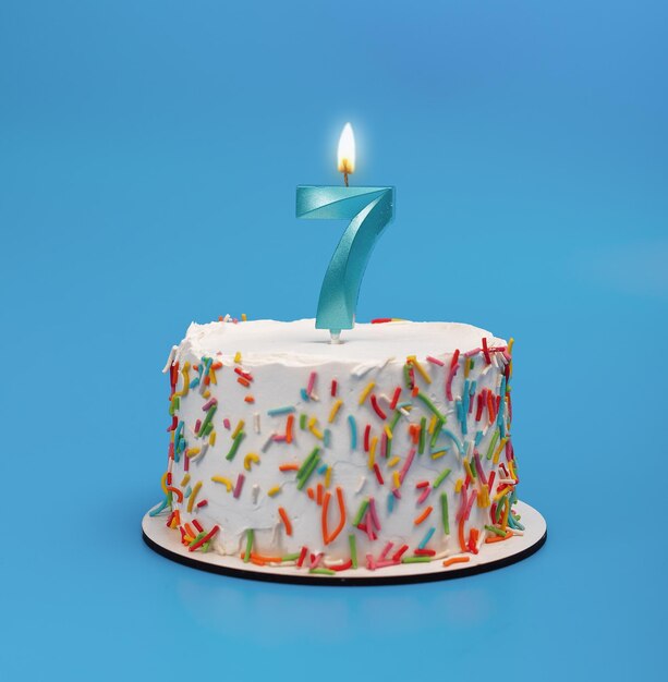 7 shaped candle light on happy birthday cake on blue