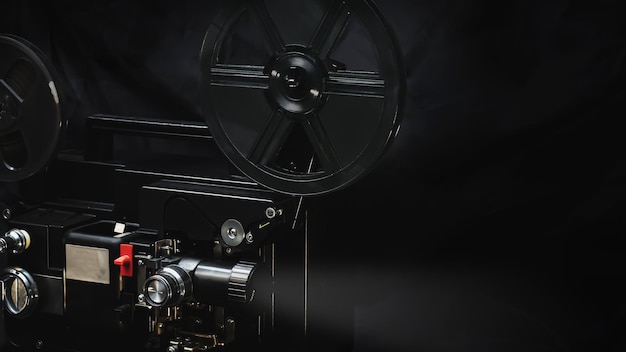 8 mm movie projector on dark background with beam