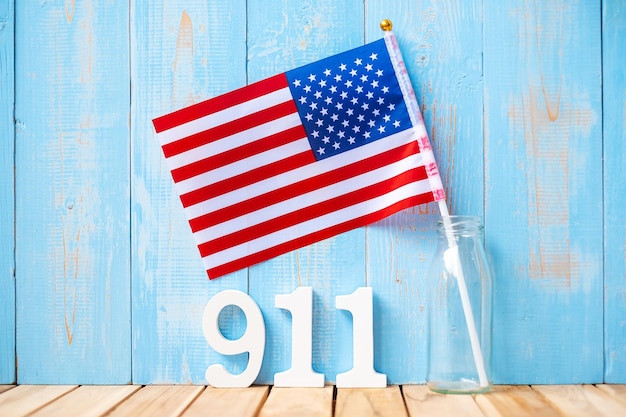 911 text and United States of America flag on wooden table background Patriot Day September memorial and Never Forget concept