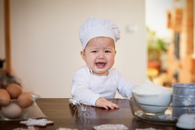 9monthold Asian baby wants to bake Christmas ginger cookies cries and demands