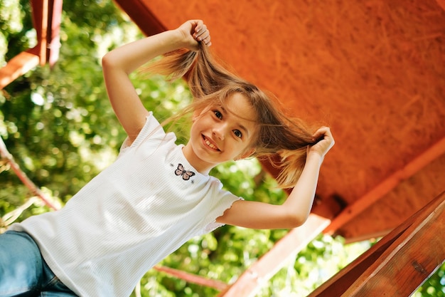 9yearold girl laughs merrily makes faces makes faces at the playground lifestyle plays