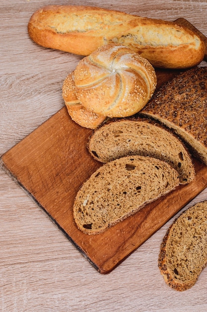 ÃÂÃÂ¡risp bread with buns. French baguettes. Fresh crispbread. Bread background. Different breed  on wooden background.