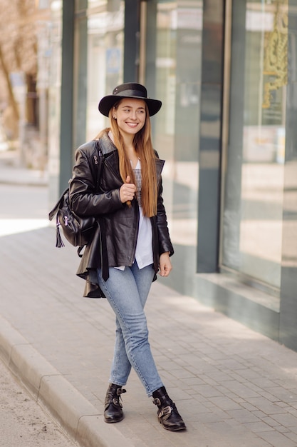 ÃÂoung pretty girl walks around the city smiling and posing