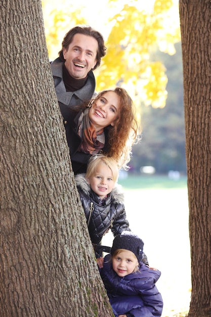 Aamily with two children in autumn forest