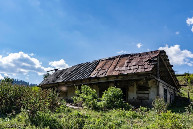 Abandoned house on field against sky