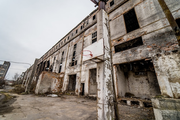 Abandoned old factory building outside. Discard old industrial factory exterior with buildings