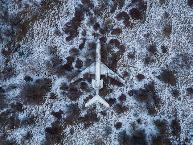 Abandoned passenger plane wreck in the forest in winter