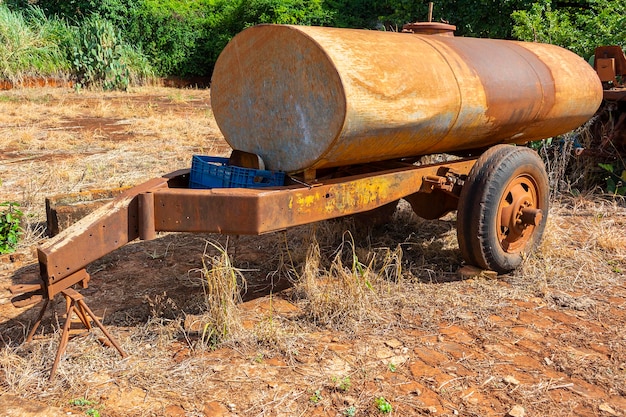 Abandoned rural water tank on sunny day