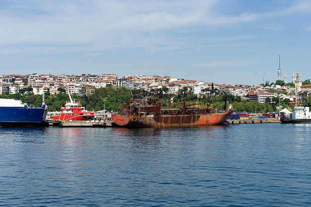 Abandoned rusty ship near coastline