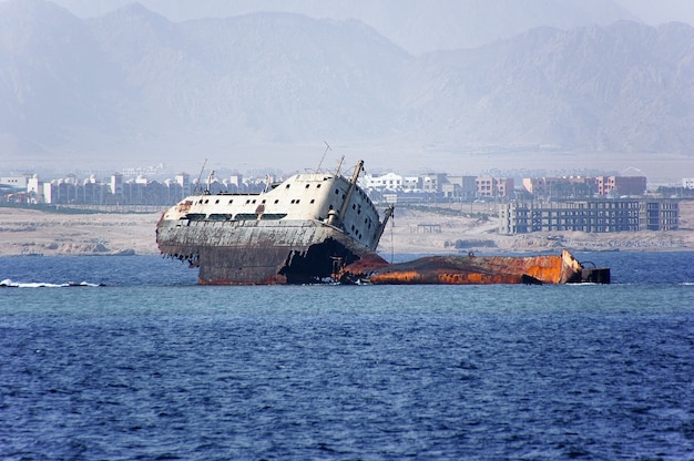 Abandoned and rusty shipwreck.