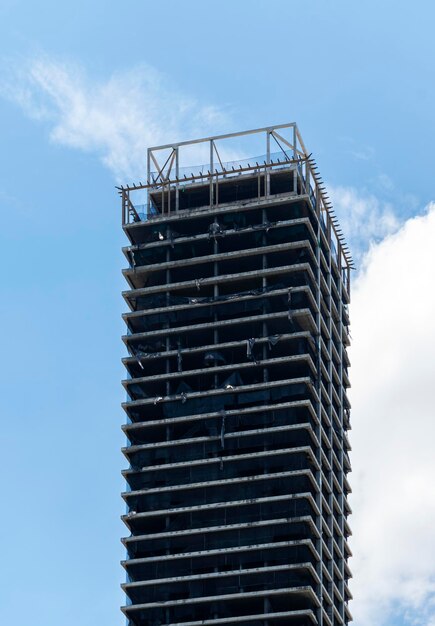 Abandoned tall building on blue sky background