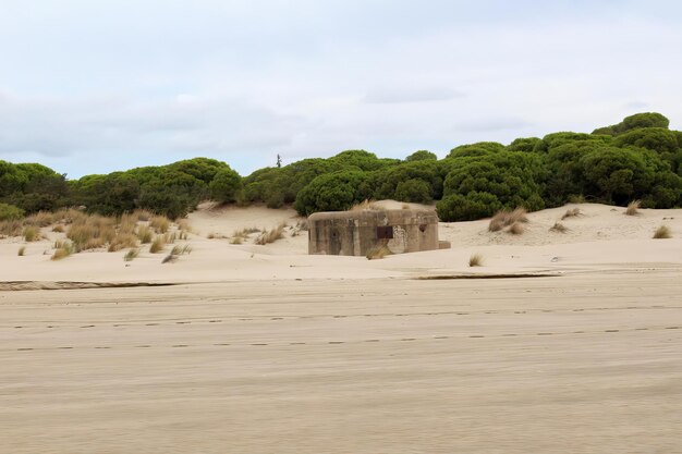 An abandoned war bunker on a deserted beach