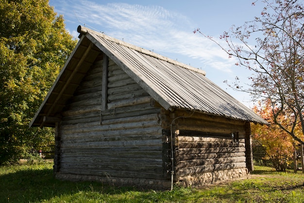 Abandoned wooden house in a dead village. Golden autumn. Old rustic architecture. High quality photo