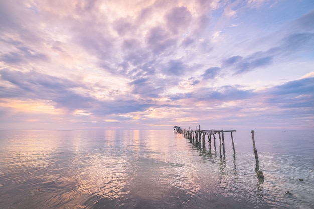 Abandoned wooden jetty at dusk, toned image