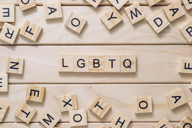 Abbreviation lgbtq with letter blocks on wooden background