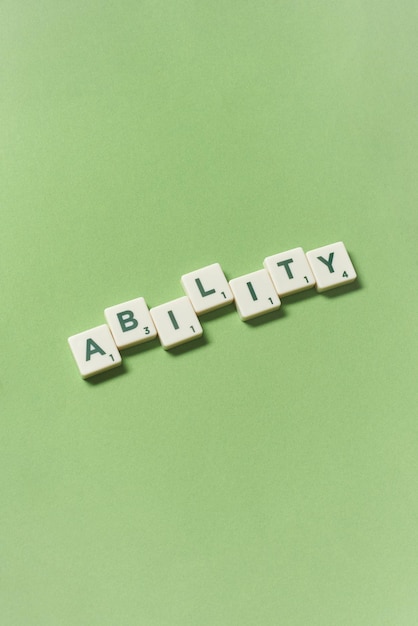 Ability formed of scrabble tiles on green background