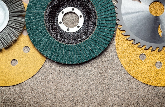 Abrasive tools and grinding discs on the background of sandpaper Tools used by master builders