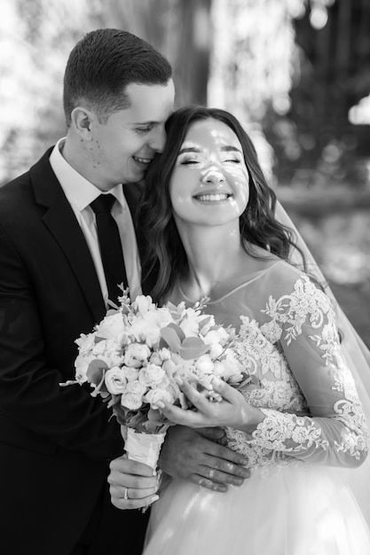 Absolutely stunning young wedding couple walking and posing in the forest.