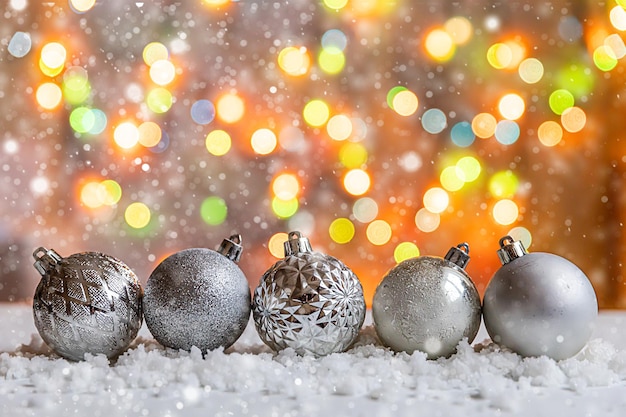 Abstract Advent Christmas Background Winter decorations ornaments balls on background with snow and defocused garland lights Merry Christmas time concept