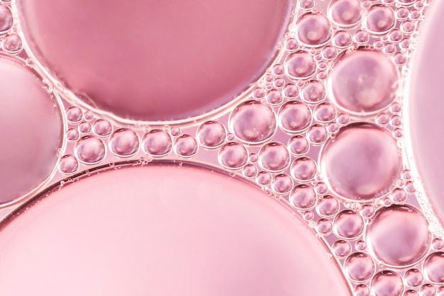 Abstract air bubbles in liquid on rose blurred background