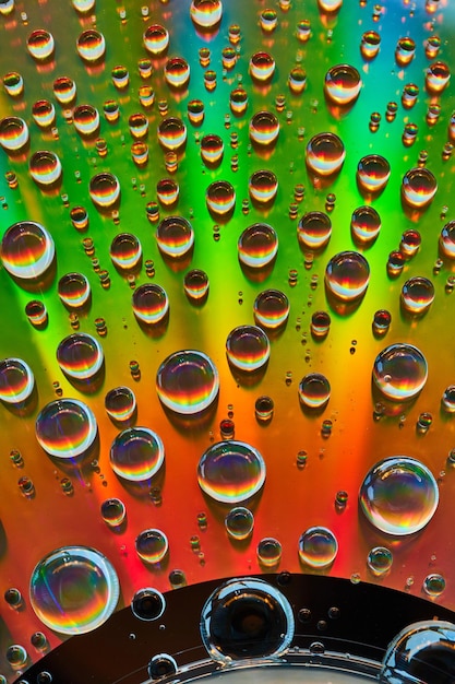 Photo abstract background asset metallic surface of rainbow colors with water droplets