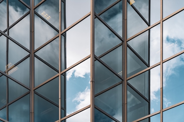 Abstract background of clouds reflected on the glazed corners of an office building