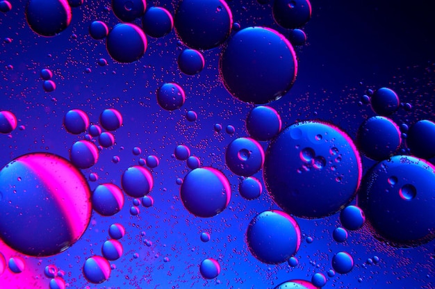 Abstract background. drops of oil on water, blue and red. macro.