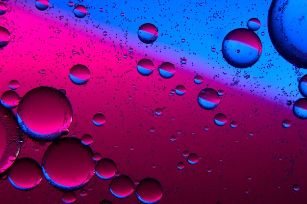 Abstract background. drops of oil on water, blue and red. macro.