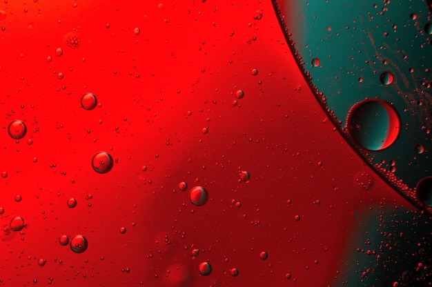 Abstract background. drops of oil on water, red and green color. macro.