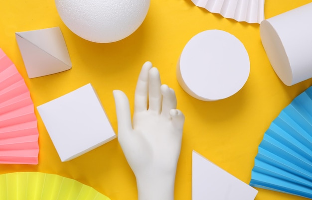 Abstract background of geometric shapes and mannequin hands