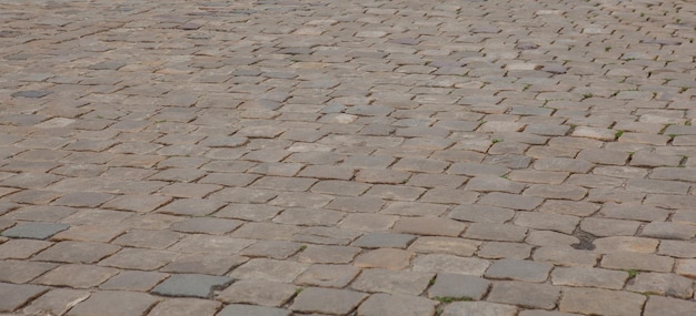 Abstract background of old cobblestone pavement closeup