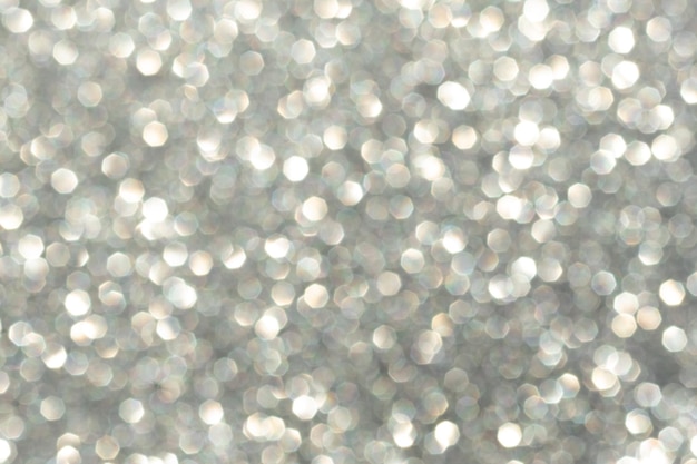 Abstract background of silver bokeh defocused blurry sparkles