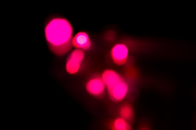 Abstract background some shiny defocused red particles on black background wallpaper