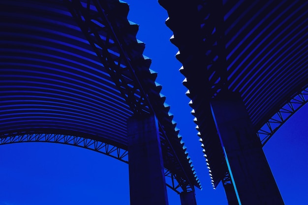 Abstract background spiral metal arch on blue sky