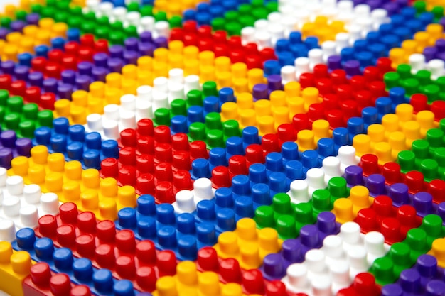 Abstract background texture of colored constructor blocks Background of colorful plastic part of constructor Pile of colored toy bricks