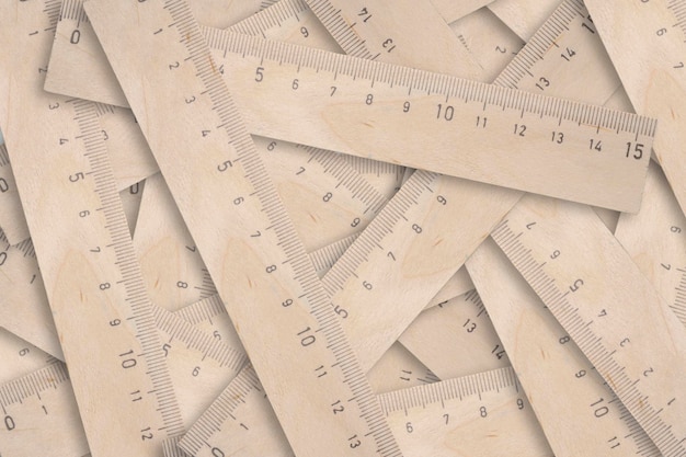 Abstract background of variety of wooden school measuring rulers