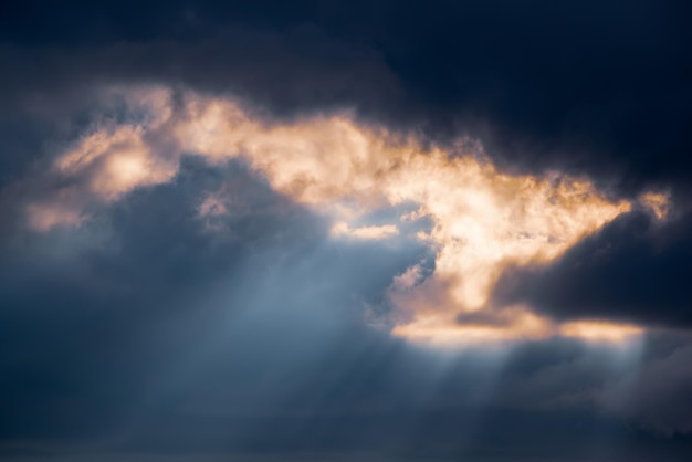 Abstract background with amazing dramatic sky at sunset Sun rays shining through the clouds