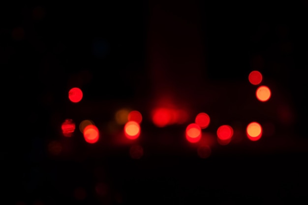 Abstract background with red bokeh on a black background