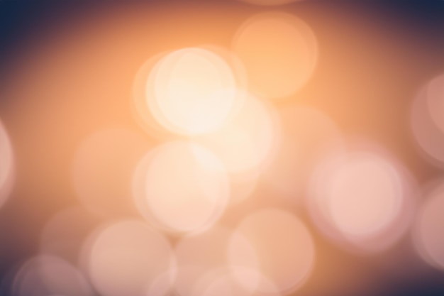 Abstract background with soft blurred circles of light in orange and pink hues